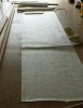 Schiaward Fiberglass mat being cut to width to wet-bed new stringer.jpg